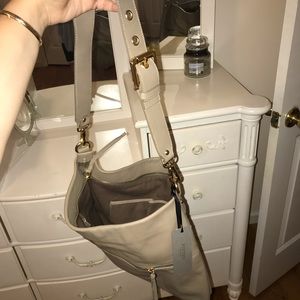 Medium sized beige bag with gold accents
